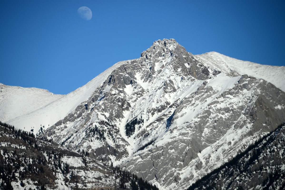 26A Cockscomb Mountain With Moon Close Up Afternoon From Trans Canada Highway Driving Between Banff And Lake Louise in Winter